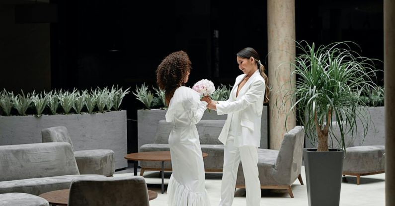 Wedding Hotels Belgrade - Man and Woman Kissing on White Floor