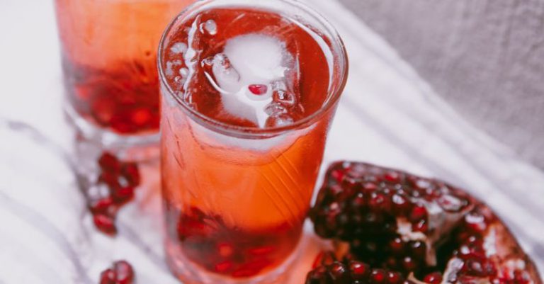 Serbian Food - Pomegranate juice and pomegranate slices on a white cloth