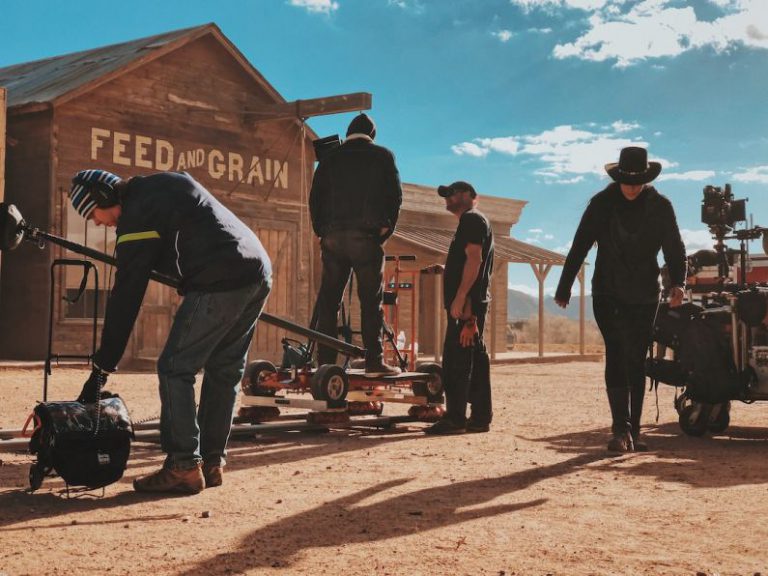 Film Scene Belgrade - four men standing outside Feed and Grain store