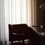 Belgrade Hotels - brown wooden chair beside white window curtain