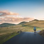 Belgrade Cycling - person cycling on road distance with mountain during daytime