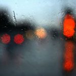 Belgrade Rainy Day - a red traffic light sitting on the side of a road