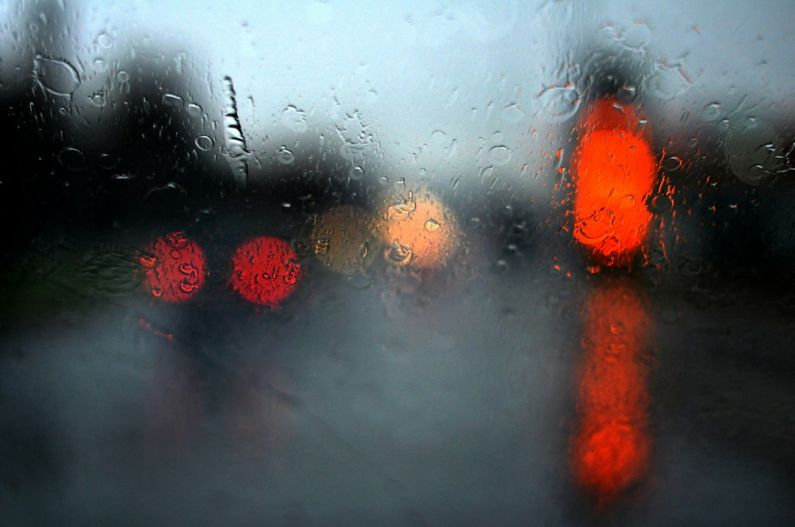 Belgrade Rainy Day - a red traffic light sitting on the side of a road