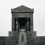 Avala Tower - 2 women standing in front of gray concrete building during daytime