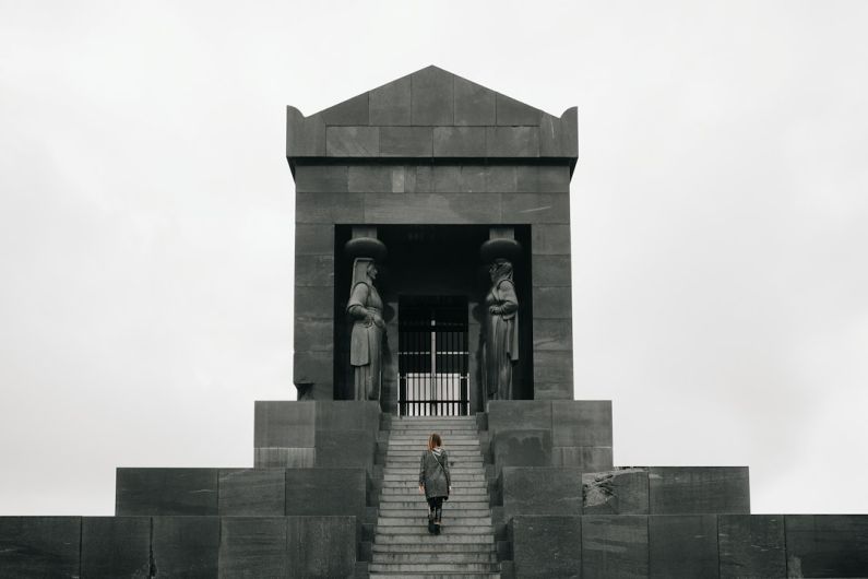 Avala Tower - 2 women standing in front of gray concrete building during daytime