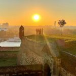Belgrade Fortress - a group of people standing on top of a grass covered field