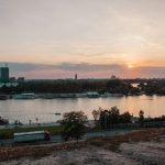 Old Town Belgrade - body of water near city buildings during sunset