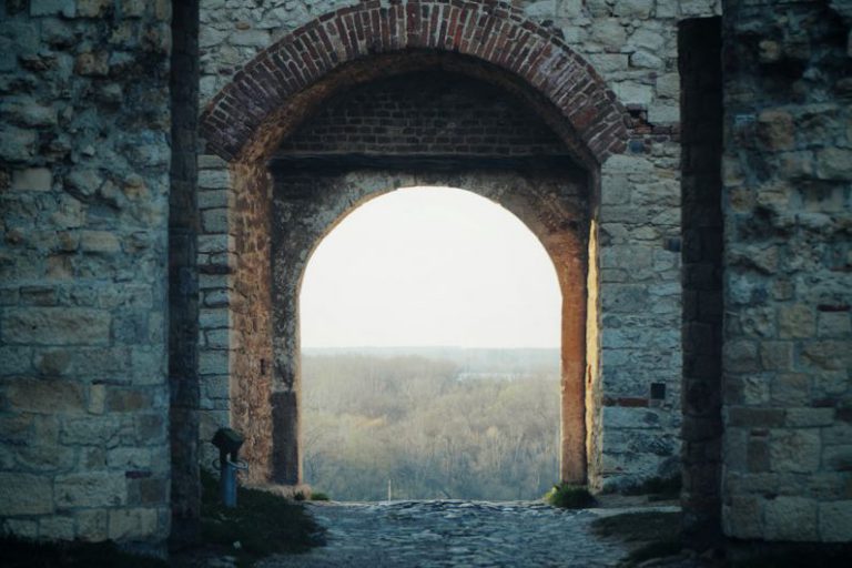 Belgrade Fortress - brown brick arch near body of water during daytime