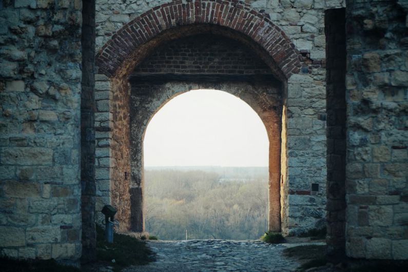 Belgrade Fortress - brown brick arch near body of water during daytime
