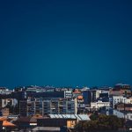 Royal Compound Belgrade - a view of a city with a plane flying in the sky