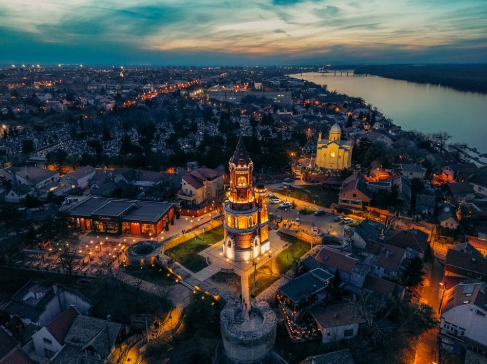 Breathtaking aerial view of Gardoš Tower illuminated at twilight in Belgrade, Serbia.