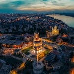 Breathtaking aerial view of Gardoš Tower illuminated at twilight in Belgrade, Serbia.