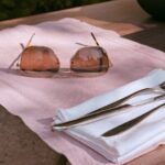 Chic outdoor table setting with sunglasses, perfect for summer vibes.