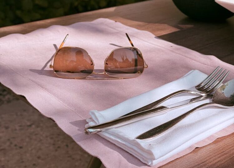 Chic outdoor table setting with sunglasses, perfect for summer vibes.