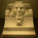 Detailed stone carving of a mythical face, a striking museum exhibit in Belgrade, Serbia.