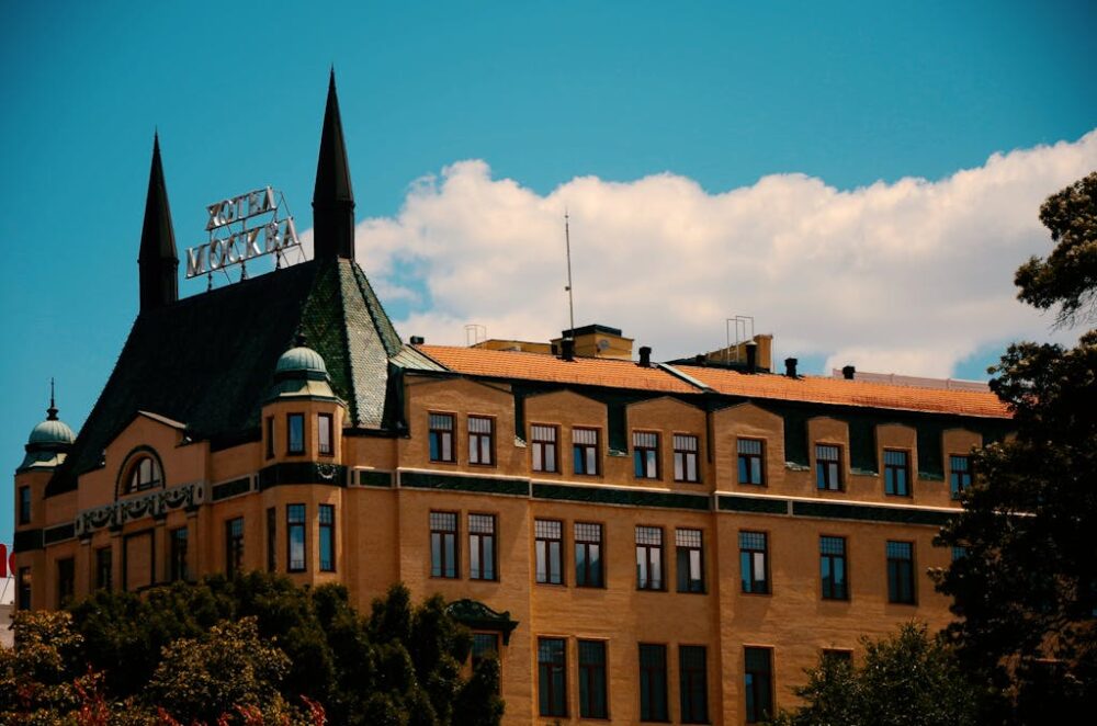 Historic hotel building with pointed spires and clear sky backdrop.