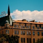 Historic hotel building with pointed spires and clear sky backdrop.