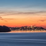Serene sunrise view of Kalemegdan Fortress reflected on the river in Belgrade, Serbia.