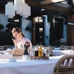Woman enjoying leisure time in a charming outdoor café setting in Belgrade, Serbia.